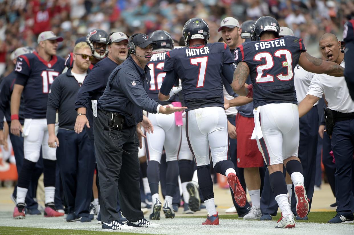 Houston Texans head coach Bill O'Brien, center, congratulates quarterback Brian Hoyer (7) and running back Arian Foster (23) after a touchdown during the first half an NFL football game against the Jacksonville Jaguars in Jacksonville, Fla., Sunday, Oct. 18, 2015. (AP Photo/Phelan M. Ebenhack)