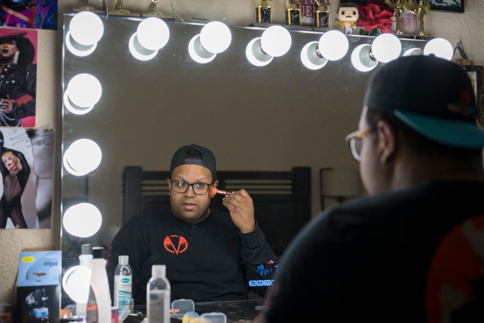 Kiba Walker, a professional drag queen who performs as Salem Moon, applies makeup at the vanity in his bedroom in Fort Worth, Texas.