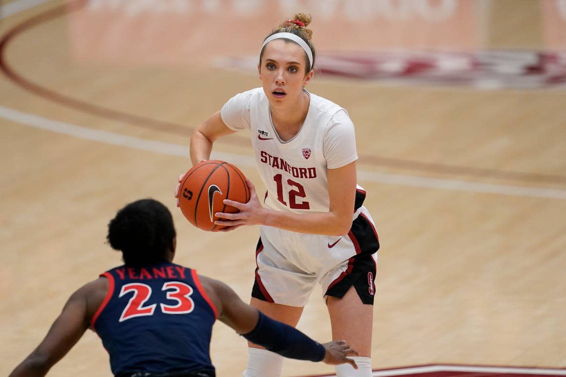 Stanford guard Lexie Hull (12) is defended by Arizona guard Bendu Yeaney (23) during an NCAA college basketball game in Stanford, Calif., Monday, Feb. 22, 2021. (AP Photo/Jeff Chiu)