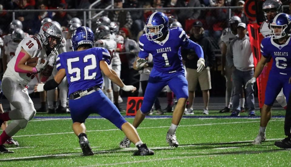 Cambridge senior Davion Bahr (1) looks for running room with during last week's Buckeye 8 battle with St. Clairsville. Bahr and the Bobcats open up OHSAA playoff action Friday with a road trip to Logan Elm.