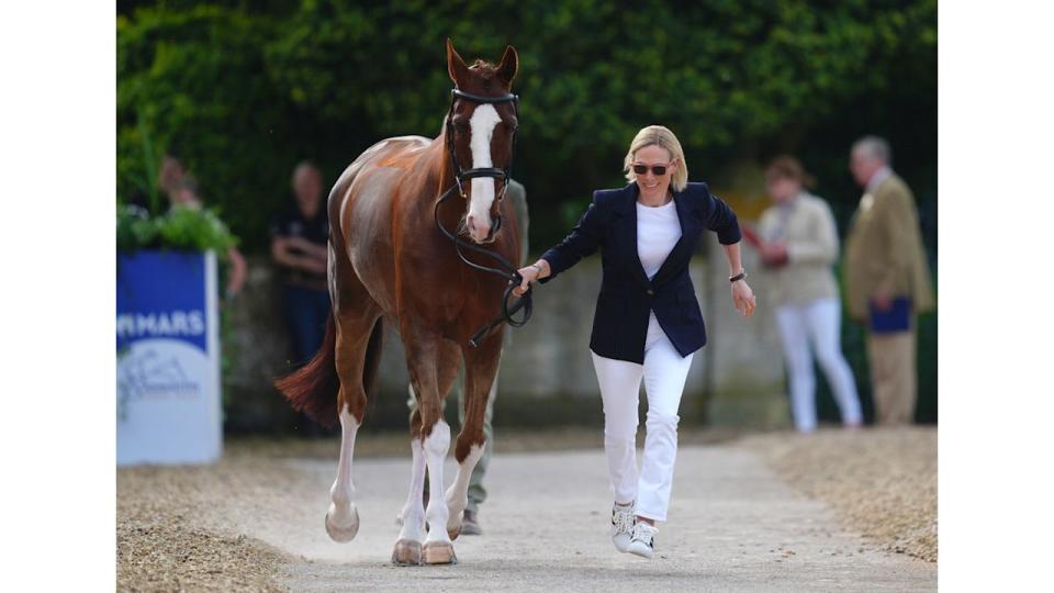 Zara Tindall running beside horse in skinny jeans 