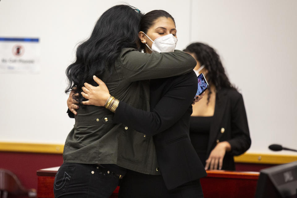Des Moines Register reporter Andrea Sahouri, facing, hugs her mother, Muna Tareh-Sahouri, after being found not-guilty at the conclusion of her trial at the Drake University Legal Clinic, Wednesday, March 10, 2021, in Des Moines, Iowa. An Iowa jury acquitted Andrea Sahouri, who was pepper-sprayed and arrested by police in the summer of 2020 while covering a protest in a case that critics have derided as an attack on press freedom and an abuse of prosecutorial discretion. (Kelsey Kremer/The Des Moines Register via AP, Pool)