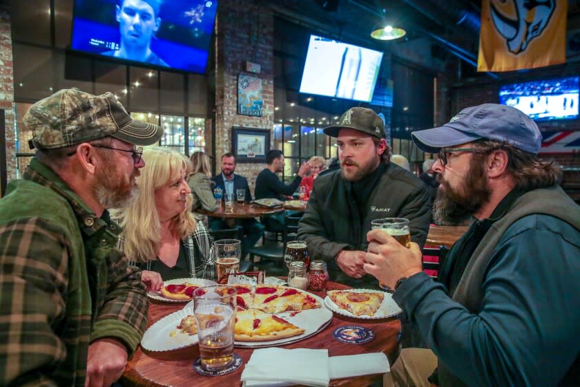 Todd Hood, center, chats with customers a his Bold Patriot Brewing Company in Nashville.