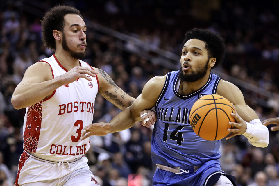 Villanova guard Caleb Daniels (14) drives to the basket past Boston College guard Jaeden Zackery during the second half of an NCAA college basketball game Saturday, Dec. 10, 2022, in Newark, N.J. Villanova won 77-56. (AP Photo/Adam Hunger)