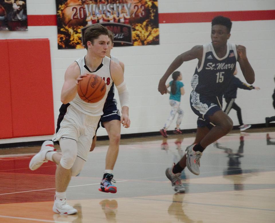 Elijah Lindbert pushes the fastbreak during a boys basketball matchup between Gaylord St. Mary's and Johannesburg-Lewiston on Friday, January 20 in Johannesburg, Mich.