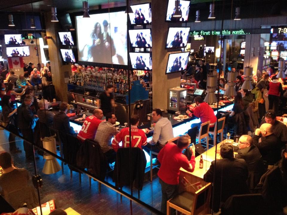 Fans watch Olympic hockey at Winnipeg's Shark Club Friday morning.