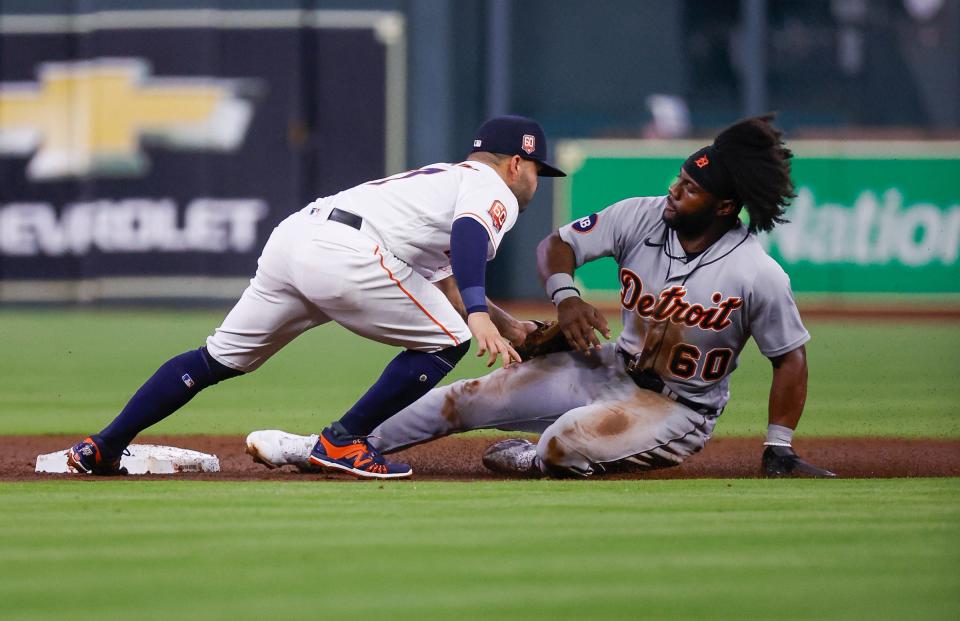 Detroit Tigers center fielder Akil Baddoo (60) is tagged out by Houston Astros second baseman Jose Altuve (27) on a play during the third inning at Minute Maid Park.