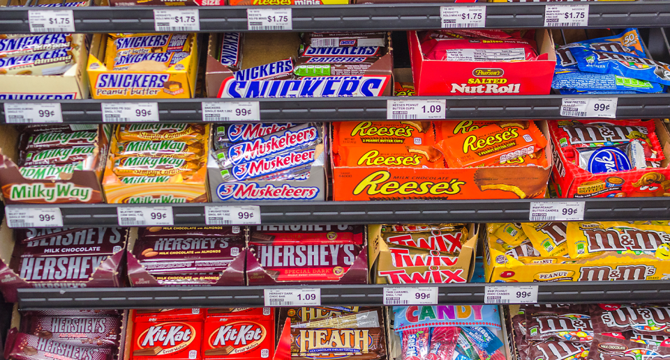 Rows of chocolate bars on shelves.