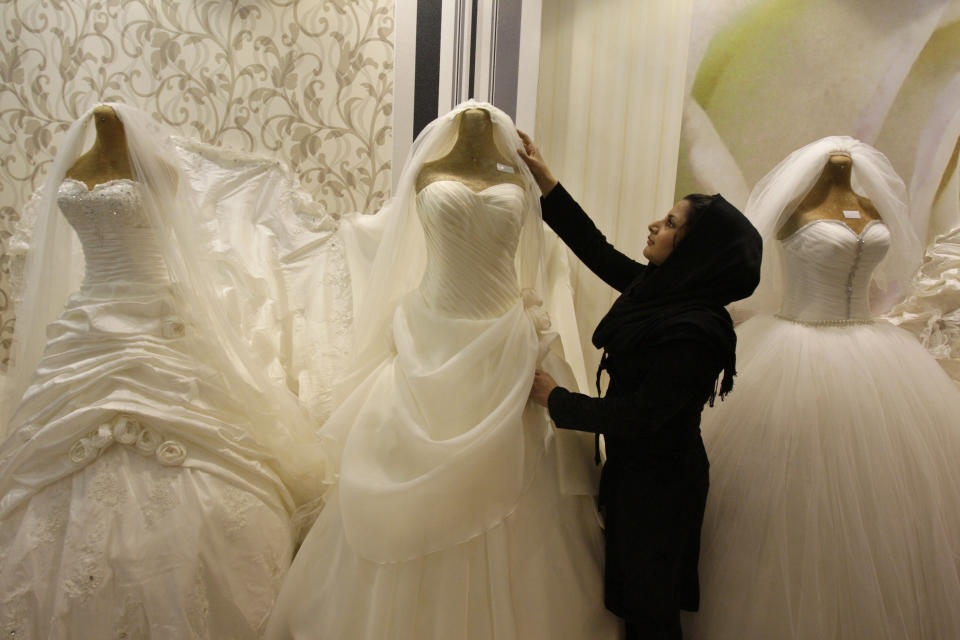 A shopkeeper adjusts a bridal costume in Tehran, on Feb. 25, 2012.