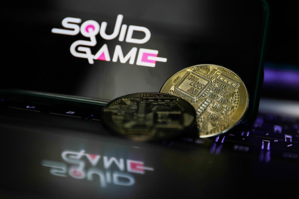Representation of cryptocurrency and Squid Game logo displayed on a phone screen are seen in this illustration photo taken in Krakow, Poland on October 30, 2021. (Photo by Jakub Porzycki/NurPhoto via Getty Images)