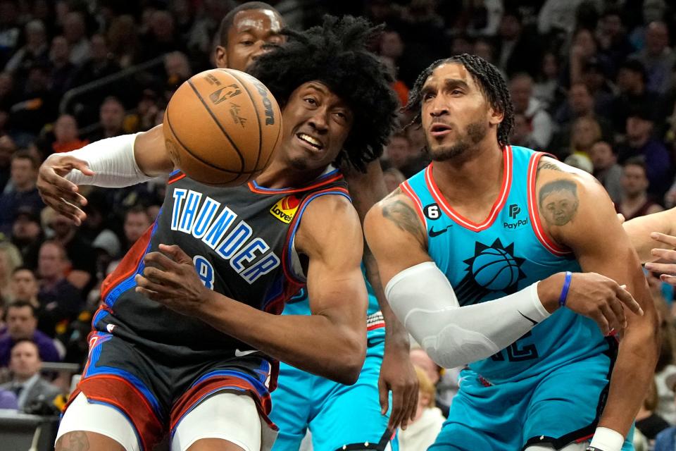 Phoenix Suns forward Ish Wainright, right, knocks the ball away from Oklahoma City Thunder forward Jalen Williams (8) during the first half of an NBA basketball game, Friday, Feb. 24, 2023, in Phoenix. (AP Photo/Rick Scuteri)