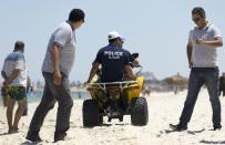 Police patrol the beach in front of the Riu Imperial Marhaba Hotel in Port el Kantaoui, on the outskirts of Sousse south of Tunisia's capital Tunis, on June 27, 2015