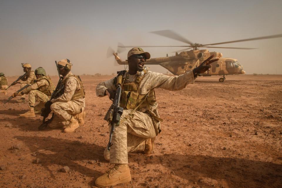 Sgt. Bashir barks orders at his fellow EFoN soldiers after exiting the aircraft during an air interdiction exercise, March 10, 2002.