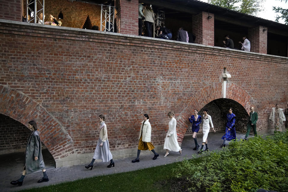 Models display the collection "Loom by Rodina" by Russian designer Svetlana Rodina at the historical Kitai-Gorod (China Town) Wall during the Fashion Week at Zaryadye Park near Red Square in Moscow, Russia, Wednesday, June 22, 2022. Chic and adventurous models and couturiers have been spread all over the Russian capital for Moscow Fashion Week, flaunting their designs in venues ranging from a sprawling Stalin-era propaganda exposition to a large park near the Kremlin admired for its innovative features. (AP Photo/Alexander Zemlianichenko)