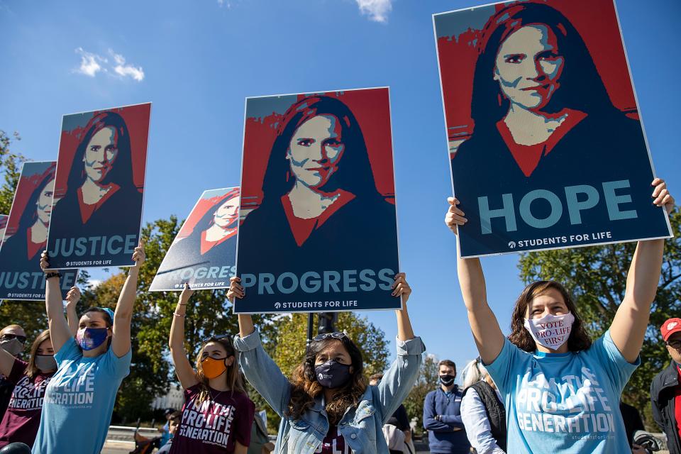 WASHINGTON, DC - OCTOBER 17: Supporters of Supreme Court nominee Judge Amy Coney Barrett show their support outside the Supreme Court on October 17, 2020 in Washington, DC. Demonstrators and supporters took to the streets in honor of the late Supreme Court Justice Ruth Bader Ginsburg and to protest President Donald Trump's nomination of Judge Amy Coney Barrett to the Supreme Court before the November election. (Photo by Tasos Katopodis/Getty Images)