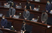 Pan-democratic legislators observe one minute of silence for the 31st anniversary of Tiananmen crackdown before a Legislative Council meeting to debate national anthem bill in Hong Kong, Thursday, June 4, 2020. On the anniversary of Tiananmen crackdown, Hong Kong continued debating a contentious law that makes it illegal to insult or abuse the Chinese national anthem. (AP Photo/Vincent Yu)