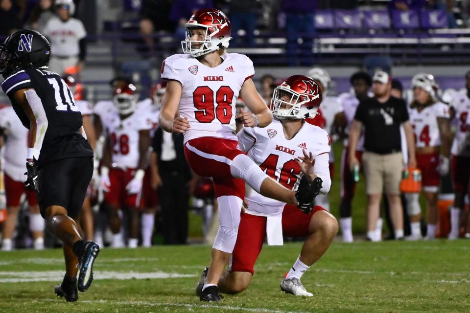 Miami (Ohio) place kicker Graham Nicholson (98) after kicking the game winning field goal as Alec Bevelhimer holds the ball against Northwestern during the second half of an NCAA college football game Saturday, Sept. 24, 2022, in Evanston, Ill.