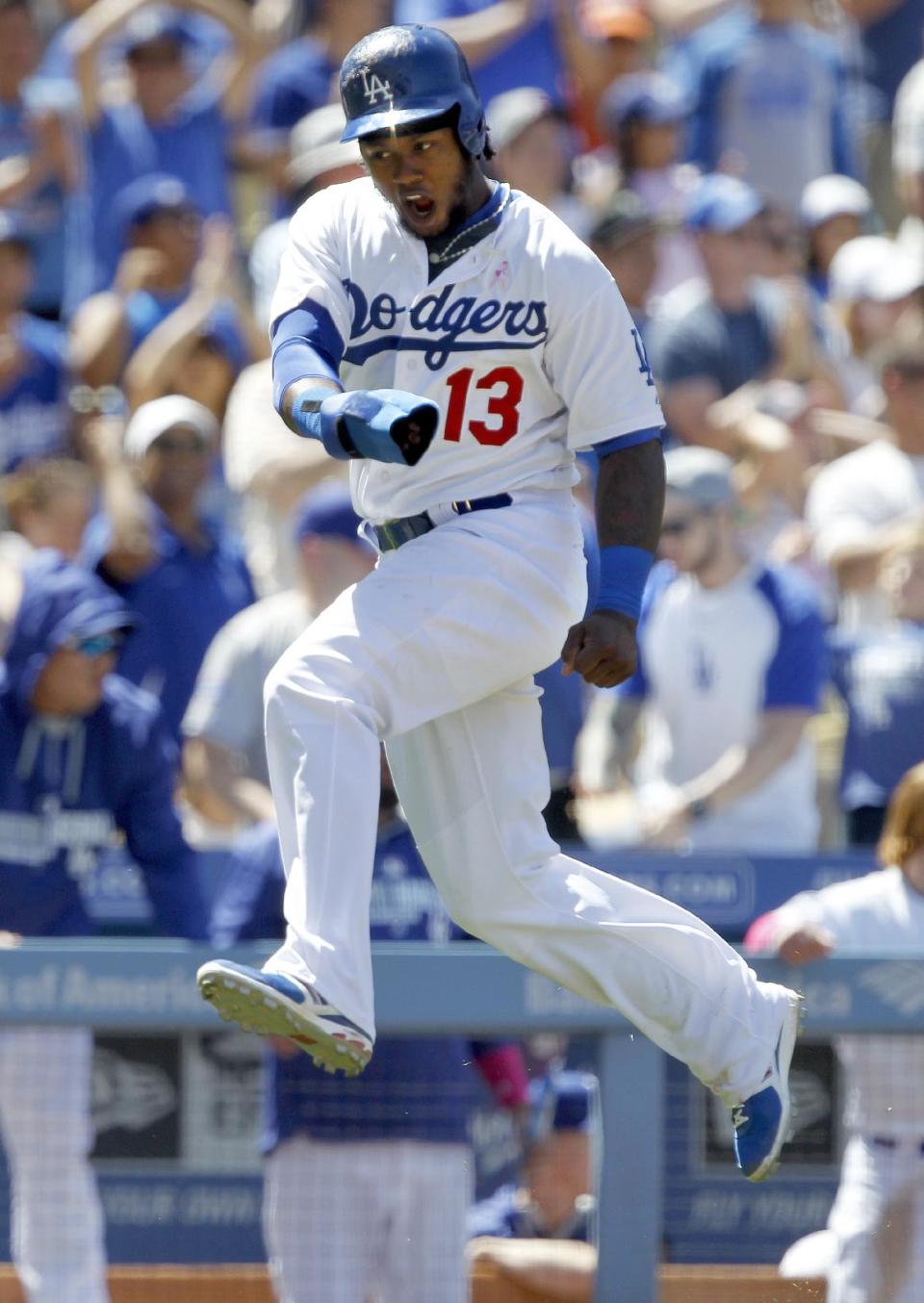 Los Angeles Dodgers’ Hanley Ramirez (13) reacts running to score at home without a throw on a single to center by the Dodgers' Adrian Gonzalez in the sixth inning of a baseball game against the San Francisco Giants on Sunday, May 11, 2014, in Los Angeles. (AP Photo/Alex Gallardo)