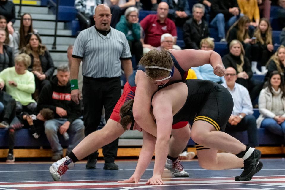 Central Bucks East's Joe Collins, top, battles Central Bucks West's Theodore Gilroy in a 285-pound match, on Wednesday, January 11, 2023, at Central Bucks East High School in Buckingham. The Patriots defeated the Bucks 50-13.