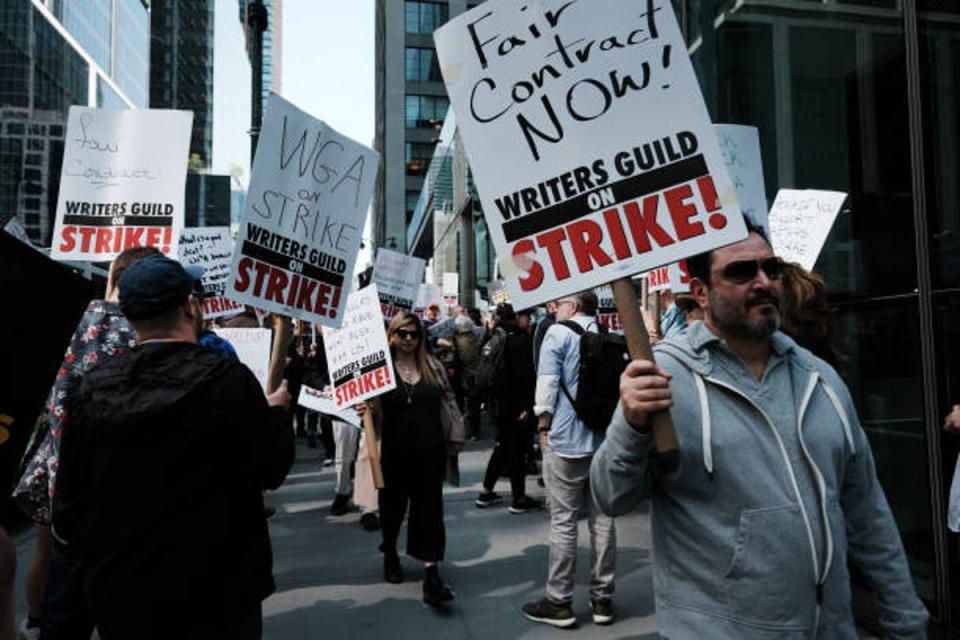 Members of the Writers Guild of America (WGA) East hold signs as they walk in the picket-line outside of HBO and Amazon’s offices on 10 May 2023 (Getty Images)