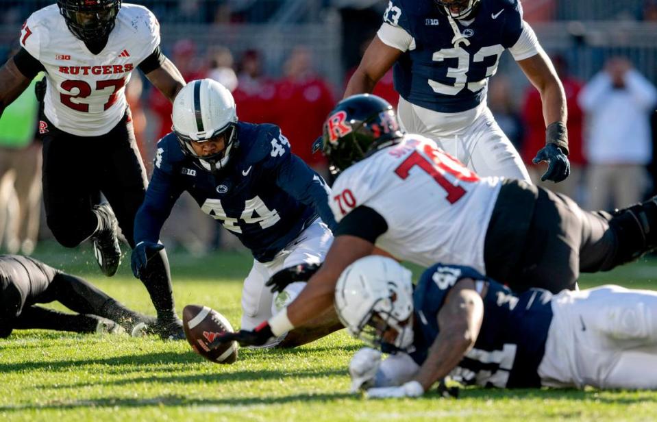 Penn State defensive end Chop Robinson dives for the ball after strip sacking Rutgers quarterback Gavin Wimsatt during the game on Saturday, Nov. 18, 2023.  