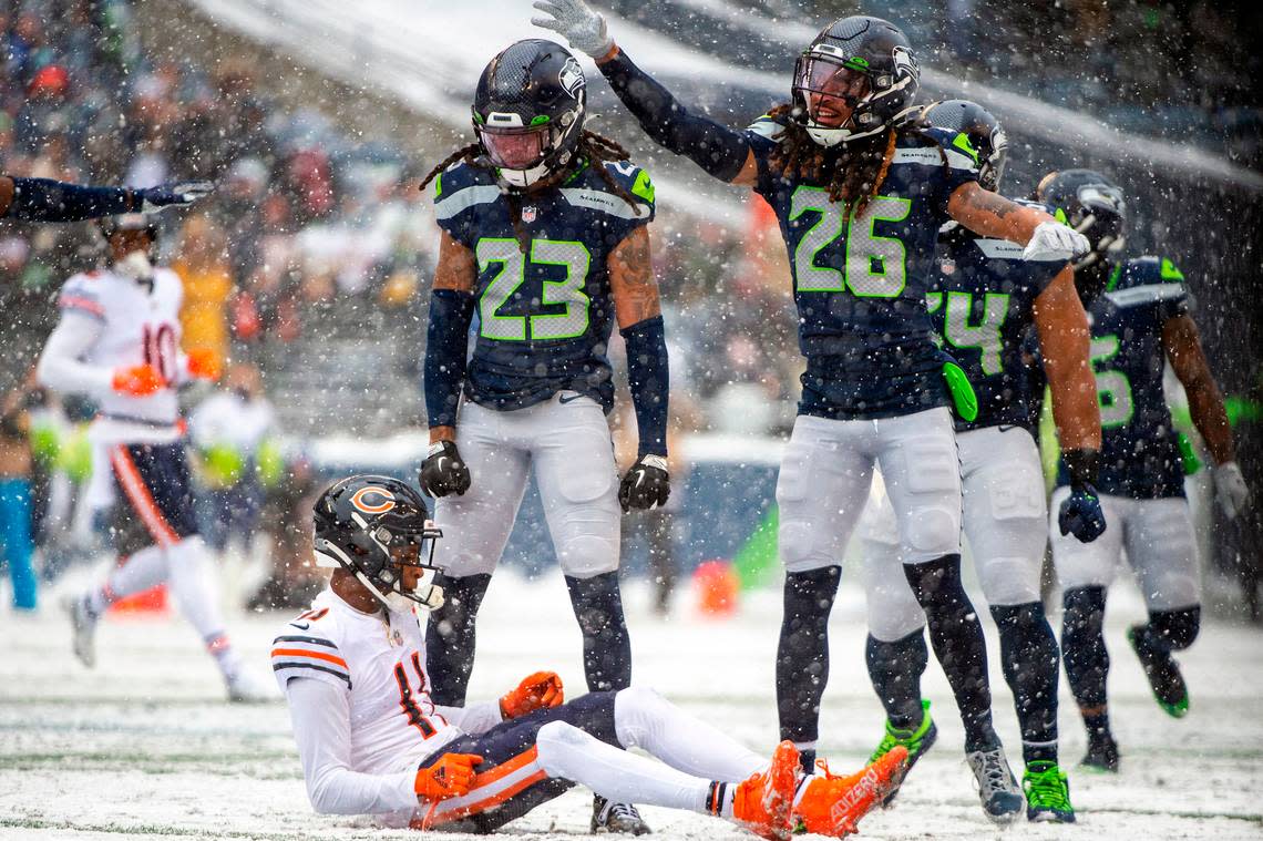 Seattle Seahawks cornerback Sidney Jones (23) and defensive back Ryan Neal (26) breaking up a pass intended for Chicago Bears wide receiver Darnell Mooney (11) during the second quarter of an NFL game on Sunday afternoon at Lumen Field in Seattle.