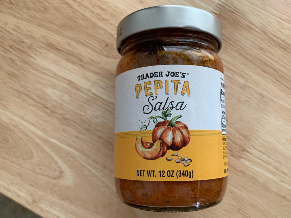 trader joes pepita salsa in jar on wood table