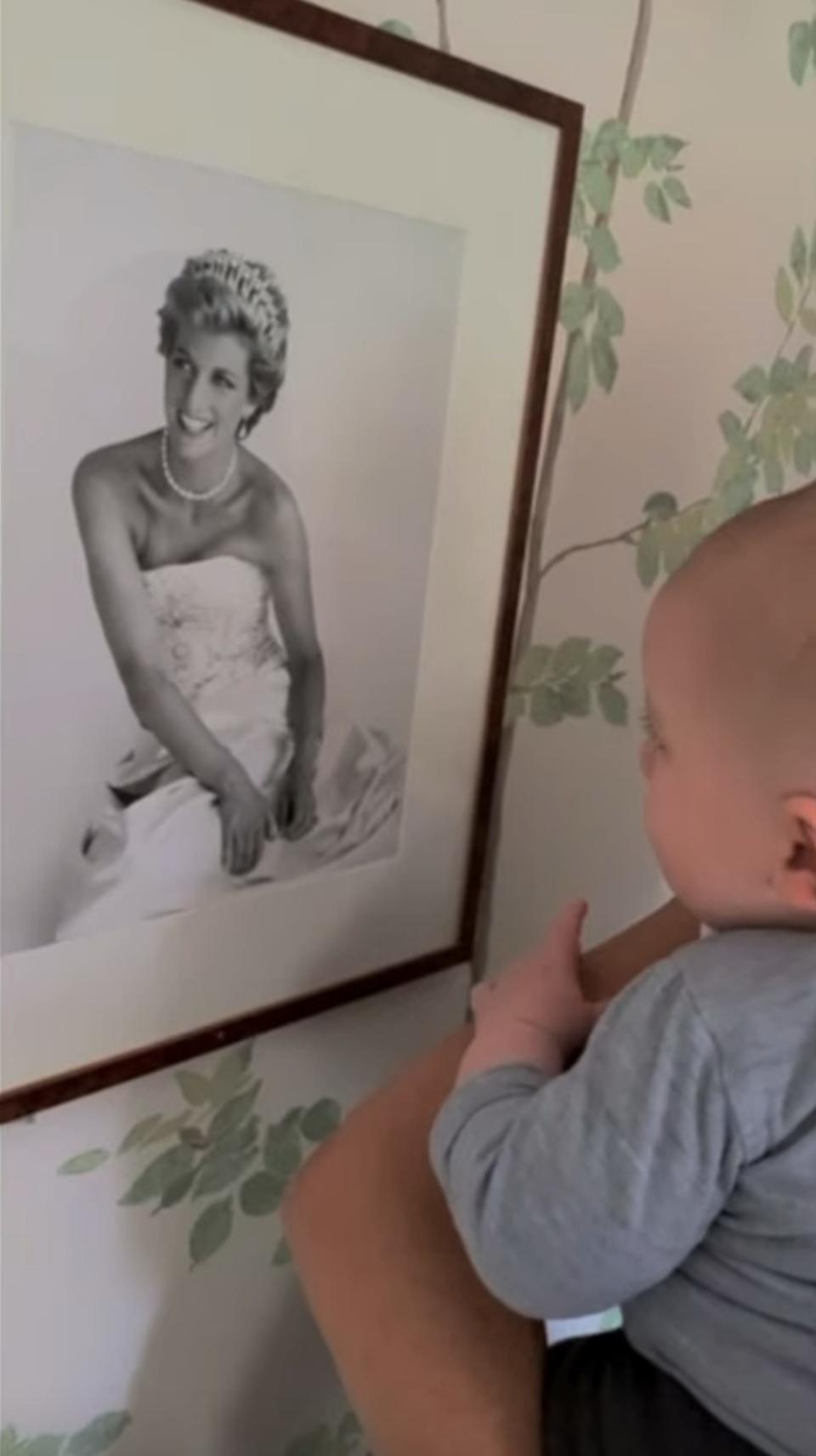 Archie looks at a photo of Princess Diana.