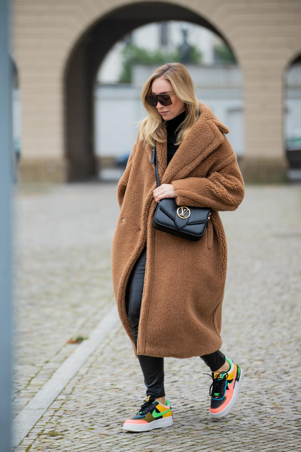 BERLIN, GERMANY - DECEMBER 09: Sonia Lyson is seen wearing brown teddy coat Max Mara, Pont Neuf Louis Vuitton bag, Nike sneaker, turtleneck in black, Vera Wang sunglasses, leather leggings H&M on December 09, 2020 in Berlin, Germany. (Photo by Christian Vierig/Getty Images)