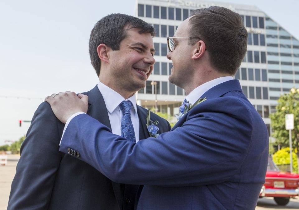 South Bend Mayor Pete Buttigieg and Chasten Glezman embrace each other following their wedding on Saturday, June 16, 2018, in downtown South Bend.