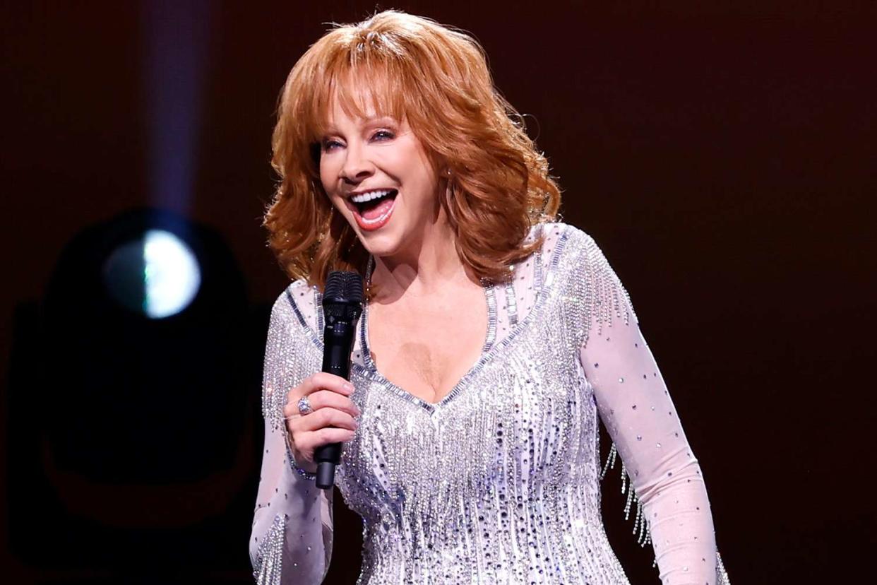 <p>Jason Kempin/Getty Images</p> Reba McEntire performs in Nashville in October 2022