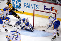 Pittsburgh Penguins center Jeff Carter (77) puts a shot behind Buffalo Sabres goaltender Michael Houser (32) for a goal during the first period of an NHL hockey game in Pittsburgh, Thursday, May 6, 2021. (AP Photo/Gene J. Puskar)