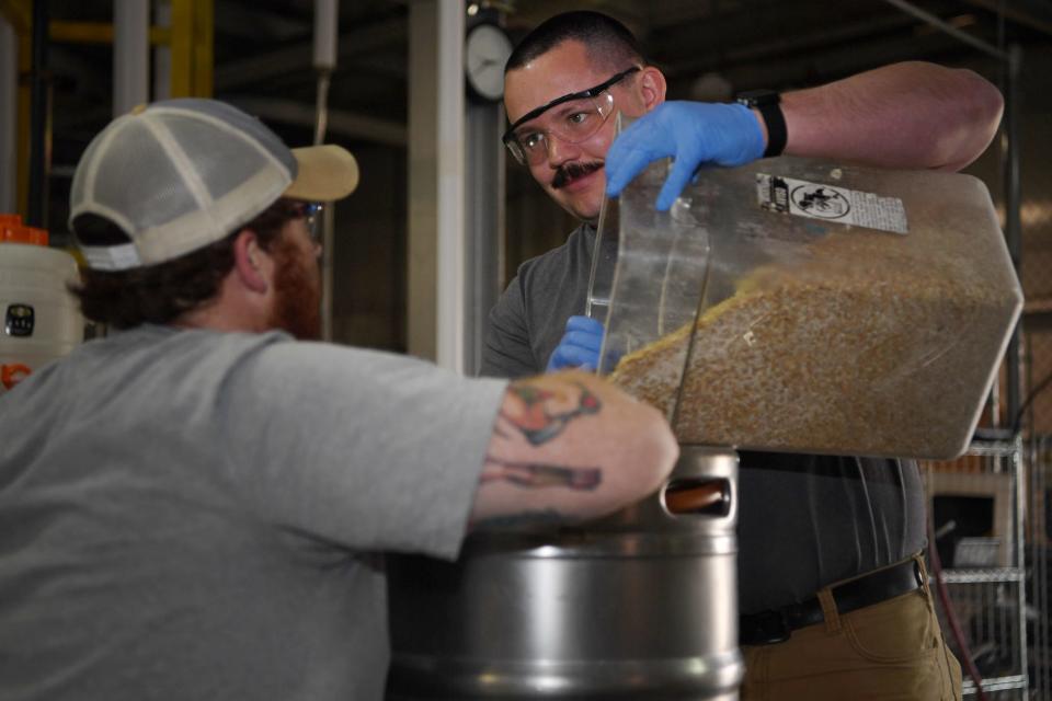 Chad Ciciora, right, and Will Lynch work together during class in the Brewing, Distillation, and Fermentation program at A-B Tech’s Enka-Candler campus, March 28, 2024.