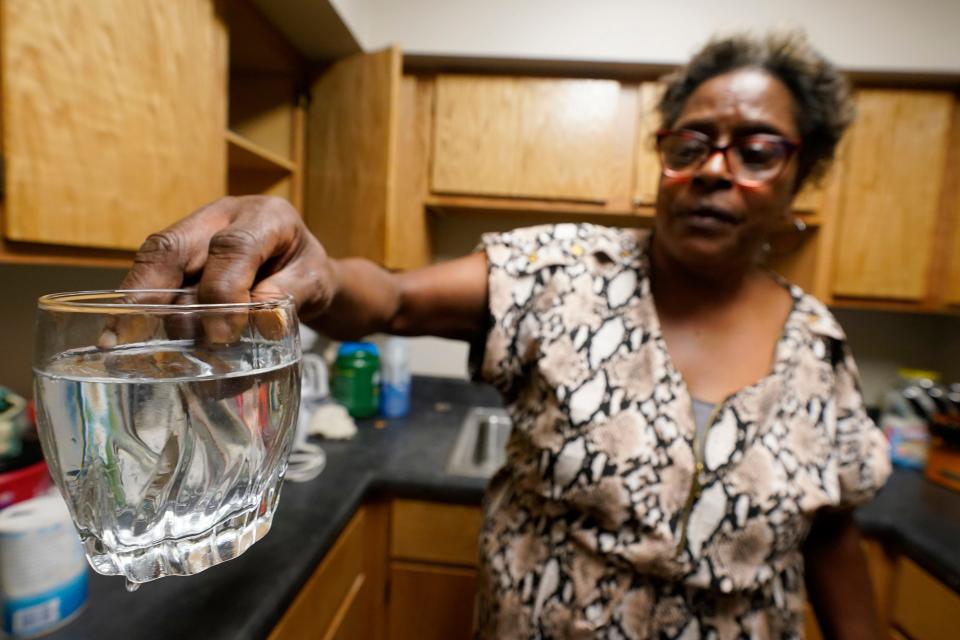 September 1, 2022: Mary Gaines a resident of the Golden Keys Senior Living apartments displays contaminated water in her kitchen in Jackson, Miss.