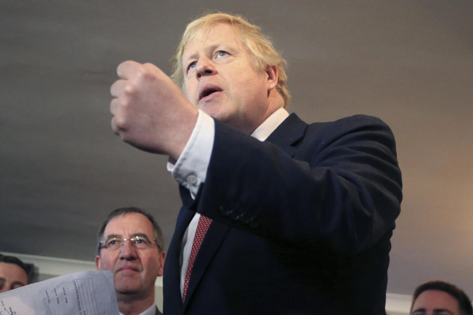 Britain's Prime Minister Boris Johnson, gestures as he speaks to supporters on a visit to meet newly elected Conservative party MP for Sedgefield, Paul Howell, at Sedgefield Cricket Club in County Durham, north east England, Saturday Dec. 14, 2019, following his Conservative party's general election victory. Johnson called on Britons to put years of bitter divisions over the country's EU membership behind them as he vowed to use his resounding election victory to finally deliver Brexit. (Lindsey Parnaby/Pool via AP)