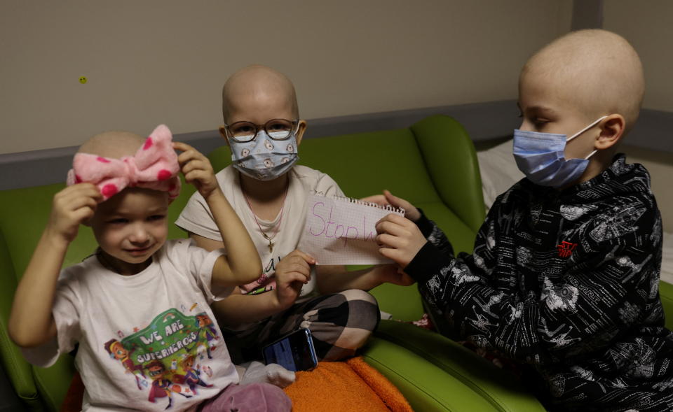 Children patients whose treatments are underway sit on chairs in the hallways of the basement floor of Okhmadet Children's Hospital, as Russia's invasion of Ukraine continues, in Kyiv, Ukraine February 28, 2022. REUTERS/Umit Bektas