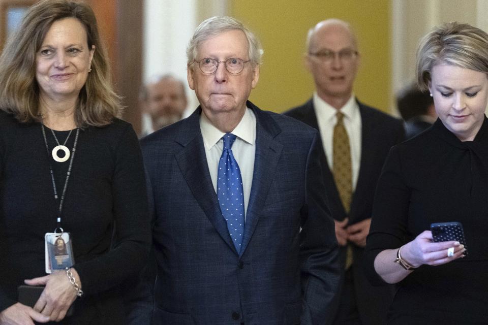 Senate Minority Leader Mitch McConnell, R-Ky., walks to his office as he talks to reporters on Capitol Hill in Washington, Tuesday, Jan. 3, 2023. (AP Photo/Jose Luis Magana)