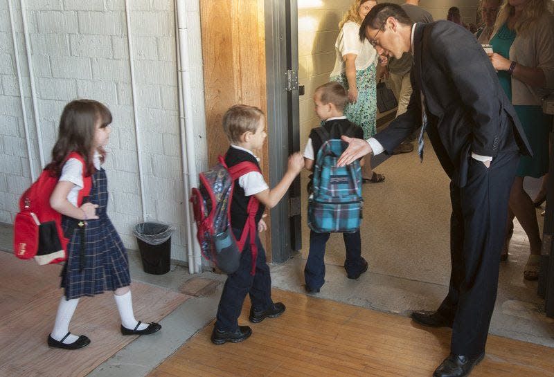 Stephen Shipp, headmaster of Seven Oaks Classical School, greets students in September 2016, on the first day of the new charter school in Ellettsville. The school is in a renovated portion of the building that once housed the Ellettsville Elementary School. David Snodgress | Herald-Times