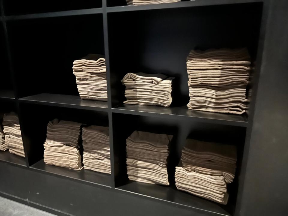 black shelves with stacks of towels