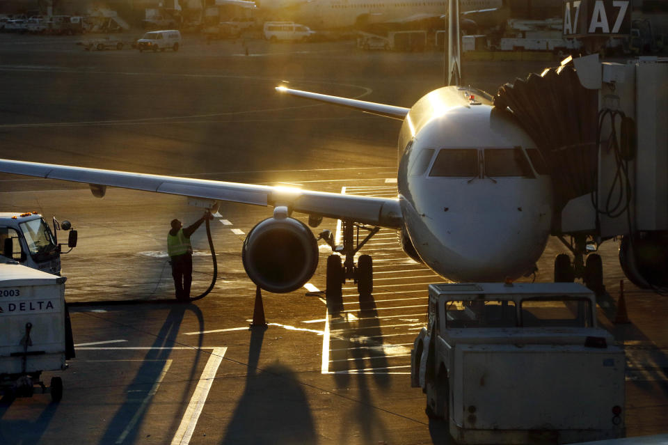 FILE - In this Dec. 8, 2018, file photo a worker fuels a Delta Connection regional airlines passenger jet at Logan International Airport in Boston. More than 7 in 10 U.S. airline passengers (72%) say ticket price is a key deciding factor when choosing an airport to fly into or from, according to a 2019 survey commissioned by NerdWallet and conducted online by The Harris Poll among more than 1,800 U.S. adults who have ever flown on an airplane. (AP Photo/Bill Sikes)