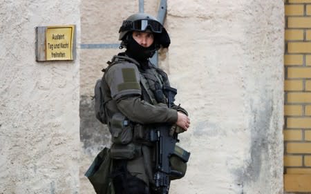 A police officer stands guard at the site of a shooting in Halle