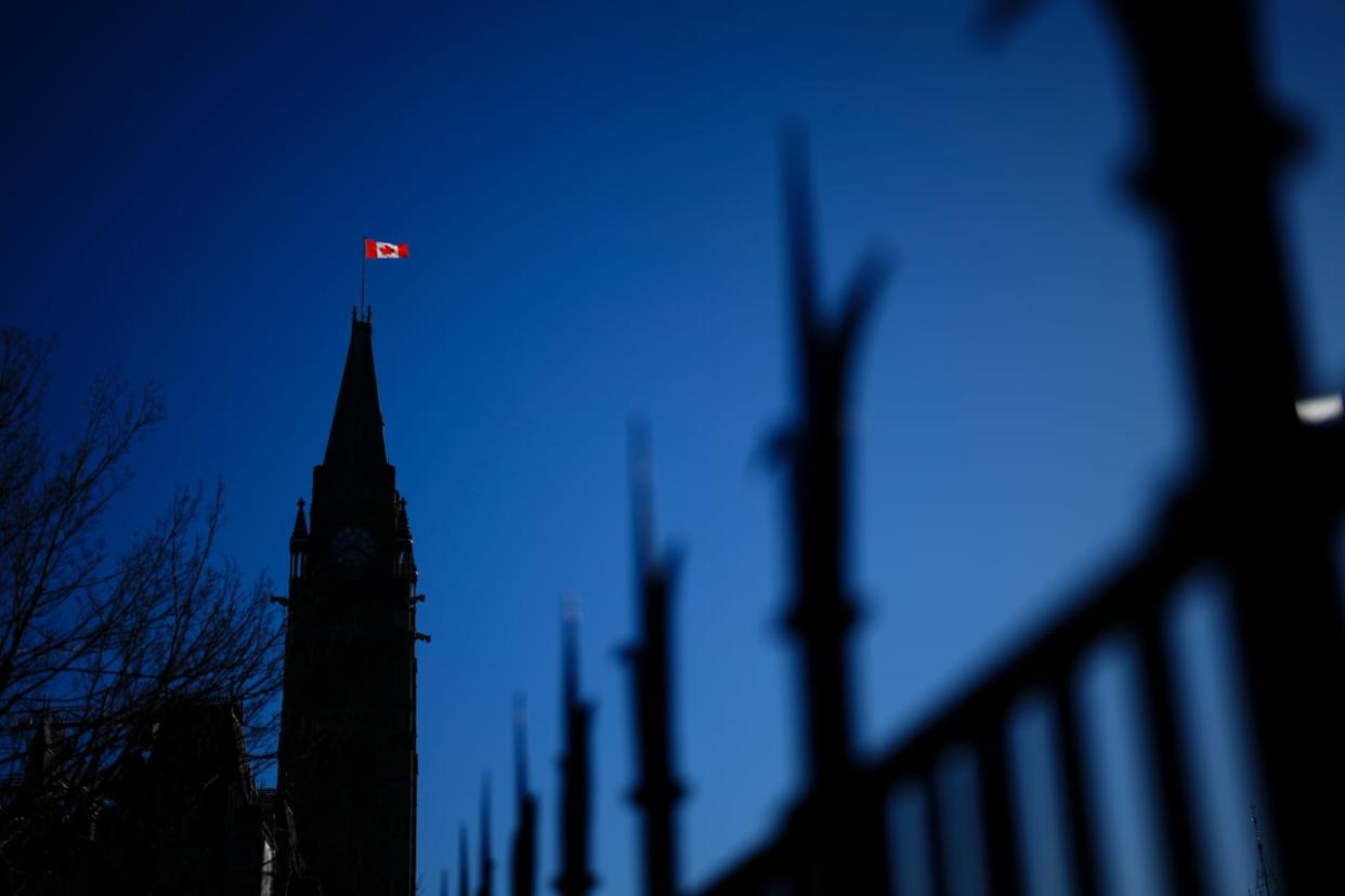 The Canadian flag catches the morning light on the Peace Tower on Parliament Hill in Ottawa on April 16. (Sean Kilpatrick/The Canadian Press - image credit)