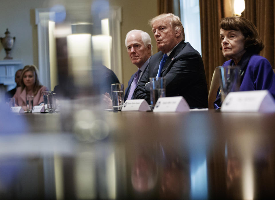FILE - From far left, Rep. Marsha Blackburn, R-Tenn.; Sen. John Cornyn, R-Texas; President Donald Trump and Sen. Dianne Feinstein, D-Calif., look across the table in the Cabinet Room of the White House, in Washington, Wednesday, Feb. 28, 2018, during a meeting with members of congress to discuss school and community safety. (AP Photo/Carolyn Kaster, File)
