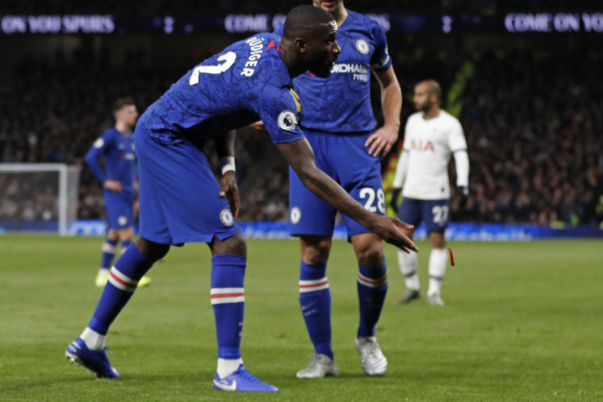 Chelsea's German defender Antonio Rudiger throws an object off the playing surface during the English Premier League football match between Tottenham Hotspur and Chelsea at Tottenham Hotspur Stadium in London, on December 22, 2019. (Photo by Adrian DENNIS / AFP) / RESTRICTED TO EDITORIAL USE. No use with unauthorized audio, video, data, fixture lists, club/league logos or 'live' services. Online in-match use limited to 120 images. An additional 40 images may be used in extra time. No video emulation. Social media in-match use limited to 120 images. An additional 40 images may be used in extra time. No use in betting publications, games or single club/league/player publications. /  (Photo by ADRIAN DENNIS/AFP via Getty Images)