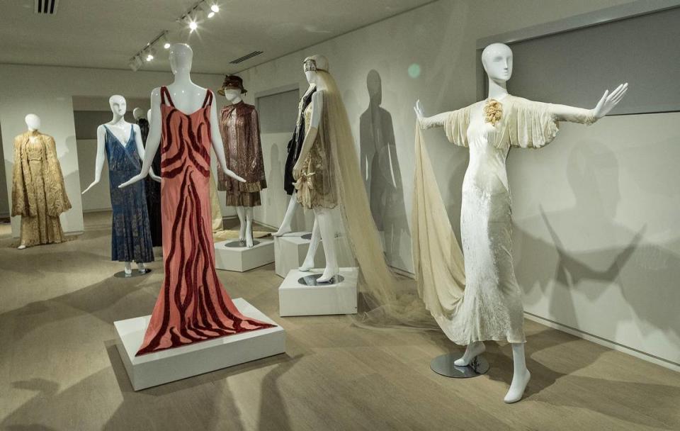 View of dresses including (from left) the “Flame Dress,” from 1926 made of pink silk with red velvet by Madeleine Vionnet; a wedding dress white tulle with gold embroidery by Paul Poiret from the 1920s and an evening dress, beige silk velvet by Elsa Schiaparelli, from 1930s.