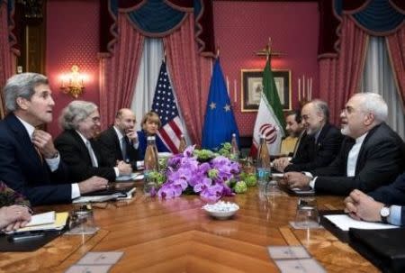 U.S. Secretary of State John Kerry (L), U.S. Secretary of Energy Ernest Moniz (2nd L), Head of the Iranian Atomic Energy Organisation Ali Akbar Salehi (2nd R) and Iranian Foreign Minister Javad Zarif (R) wait with others ahead of a meeting at the Beau Rivage Palace Hotel in Lausanne on March 26, 2015 during negotiations on the Iranian nuclear programme. REUTERS/Brendan Smialowski/Pool