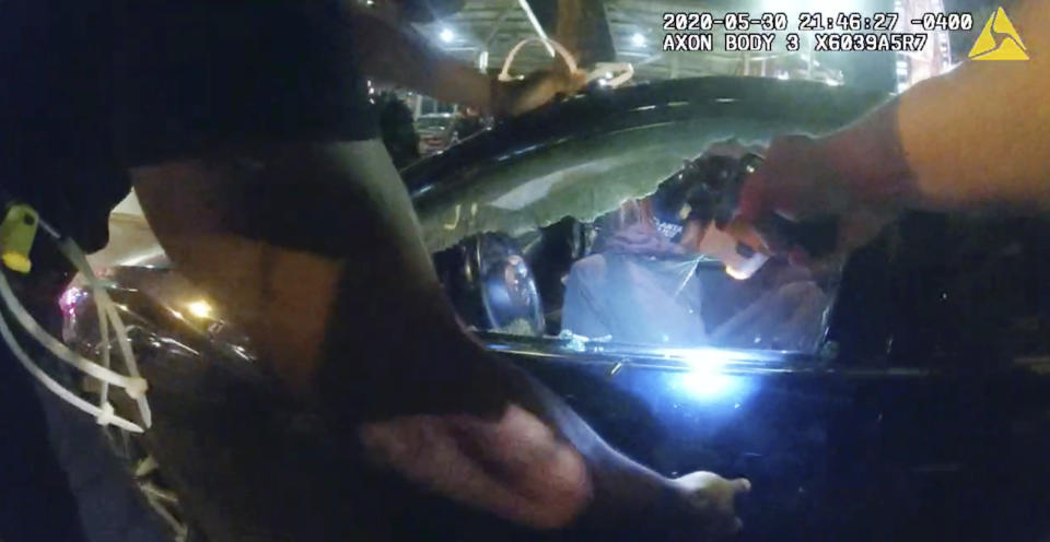 FILE - In this photo taken from police body camera video released by the Atlanta Police Department, an officer points his handgun at Messiah Young while the college student is seated in his vehicle, in Atlanta, Saturday, May 30, 2020. On Monday, May 23, 2022, a prosecutor said he would not prosecute Atlanta police officers involved in a May 2020 confrontation with two college students who were stunned with Tasers and pulled from a car while they were stuck in traffic caused by protests over George Floyd’s death. (Atlanta Police Department via AP, File)