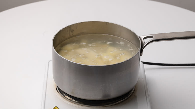 boiling potatoes in a saucepan