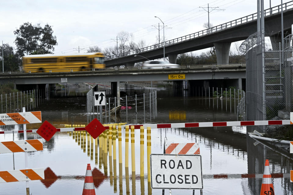 Vehicles drive on California State Route 163 over a flooded street Tuesday, Feb. 6, 2024, in San Diego. The National Weather Service issued a brief tornado warning for parts of East San Diego county. The warning was cancelled shortly after it was issued, with forecasters explaining that the storm no longer appeared capable of producing a twister even if it briefly turned some San Diego streets into rivers. (AP Photo/Denis Poroy)