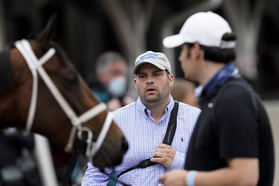 Brad Cox, trainer for Kentucky Derby entrant Essential Quality, prepares horses for a workout at Churchill Downs Thursday, April 29, 2021, in Louisville, Ky. The 147th running of the Kentucky Derby is scheduled for Saturday, May 1. (AP Photo/Charlie Riedel)